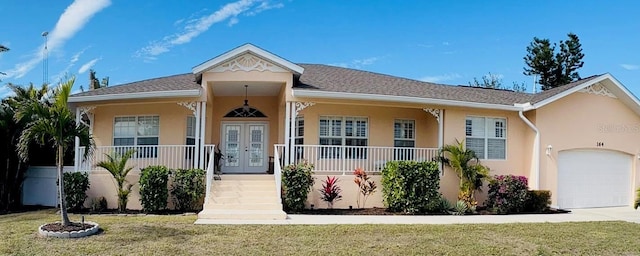 view of front facade featuring a garage, a front lawn, covered porch, and french doors