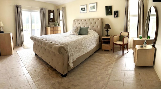 bedroom featuring light tile patterned floors and access to outside