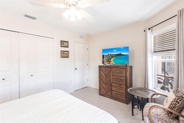 tiled bedroom with a closet and ceiling fan