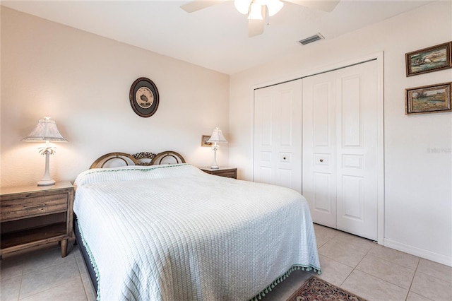 bedroom featuring light tile patterned floors, a closet, and ceiling fan