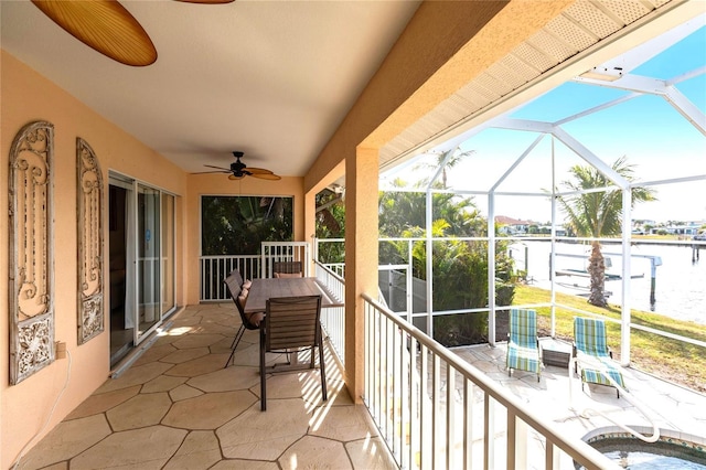 exterior space with a water view, ceiling fan, and a patio