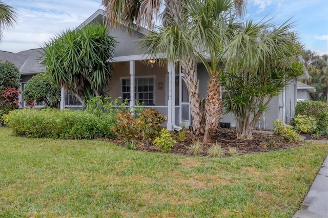 view of side of property featuring a lawn