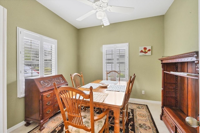 tiled dining space with ceiling fan