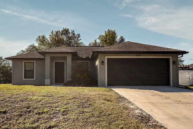 view of front of property with a garage and a front yard