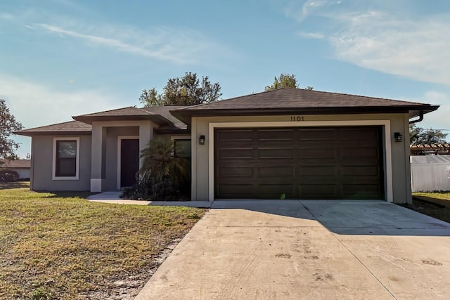 view of front of home featuring a garage and a front yard