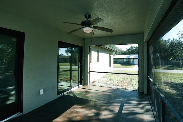 sunroom / solarium featuring ceiling fan