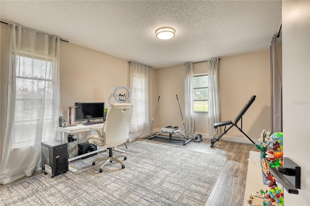 office space featuring light hardwood / wood-style flooring and a textured ceiling