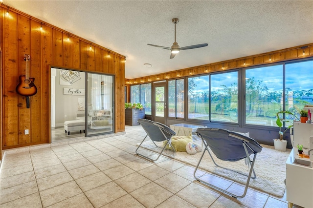 sunroom featuring ceiling fan and a healthy amount of sunlight