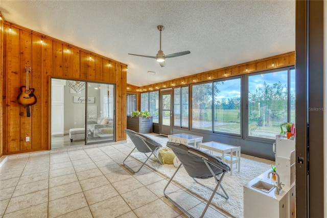 sunroom featuring ceiling fan