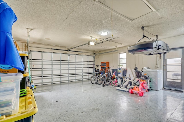 garage with washer / clothes dryer and a garage door opener