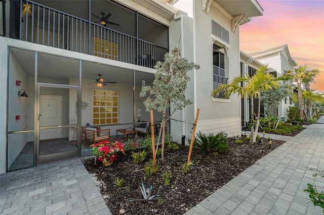 exterior entry at dusk with ceiling fan