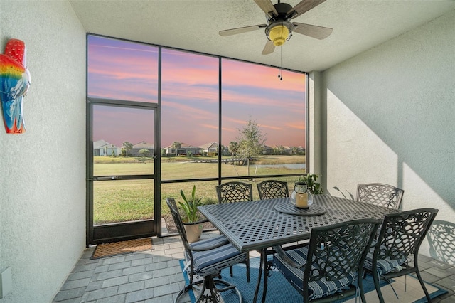 sunroom featuring ceiling fan