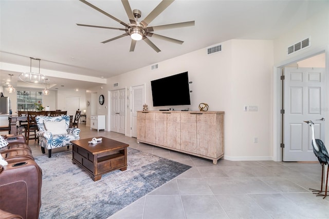 living room featuring light tile patterned floors and ceiling fan