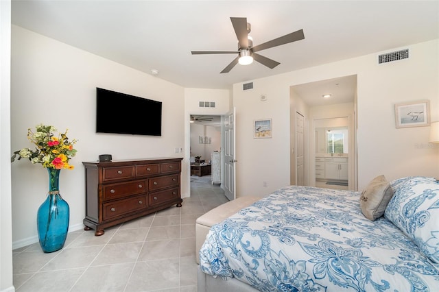 bedroom with light tile patterned flooring, ceiling fan, and ensuite bathroom