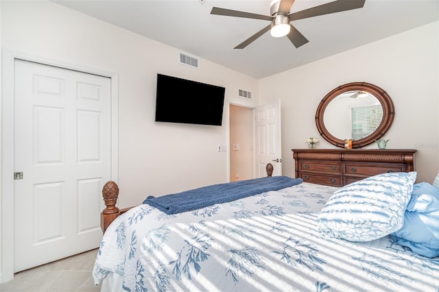 bedroom with ceiling fan and light tile patterned floors