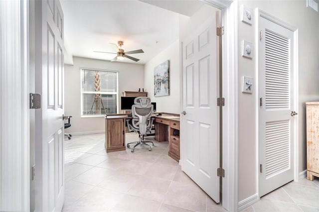 tiled office space with ceiling fan