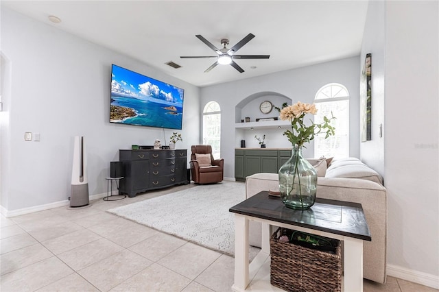 living room featuring ceiling fan and tile patterned flooring