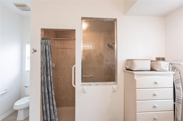 bathroom with tile patterned floors, toilet, and a shower with curtain