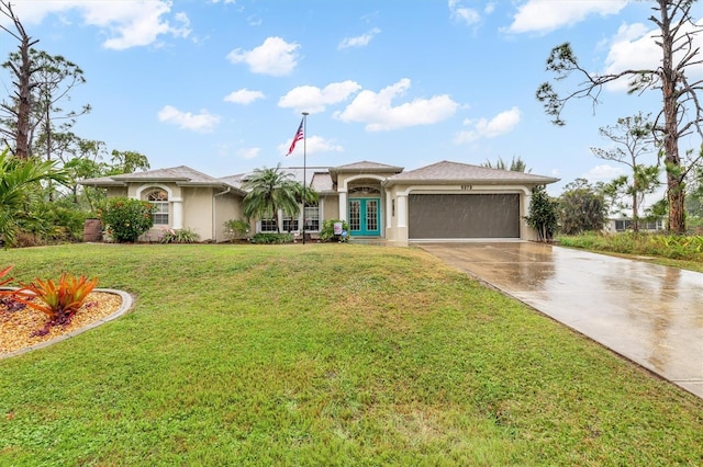 view of front of property featuring a garage, a front yard, and french doors