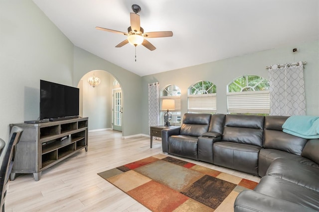 living room with light hardwood / wood-style floors, ceiling fan, and vaulted ceiling