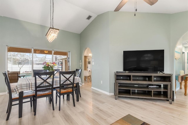 dining room featuring lofted ceiling, light hardwood / wood-style floors, and ceiling fan