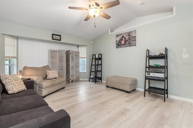 living room featuring ceiling fan, vaulted ceiling, and light wood-type flooring