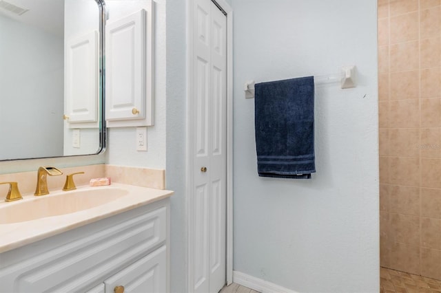 bathroom featuring vanity and a tile shower