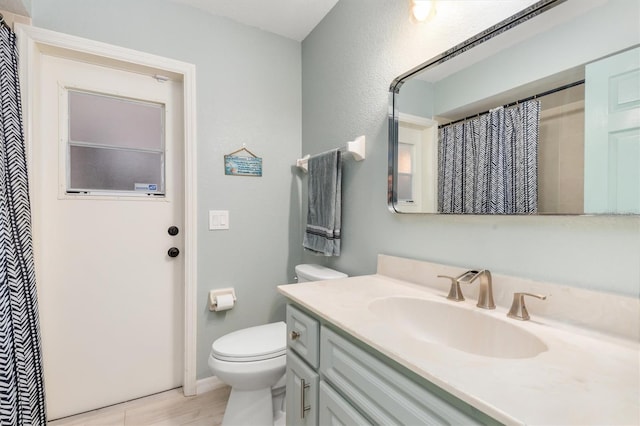 bathroom with vanity, toilet, and a shower with shower curtain