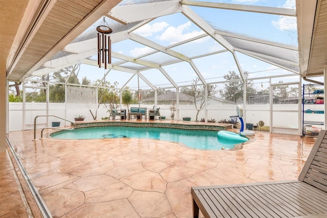 view of pool with a patio area and a lanai