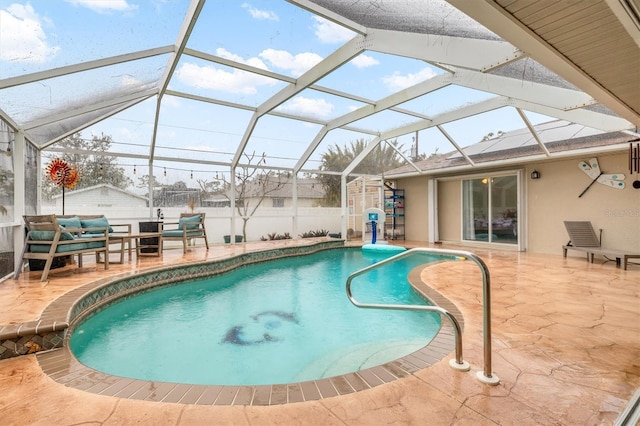 view of swimming pool featuring glass enclosure and a patio area