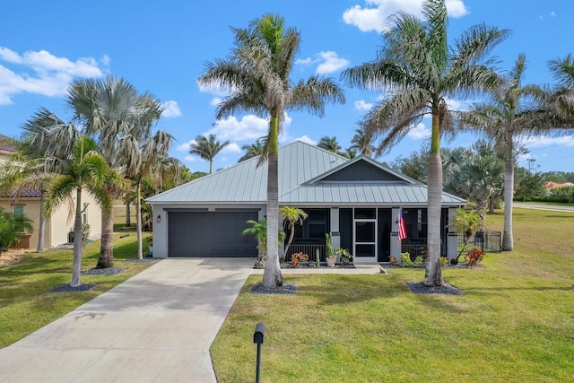 view of front facade with a porch, a garage, and a front lawn