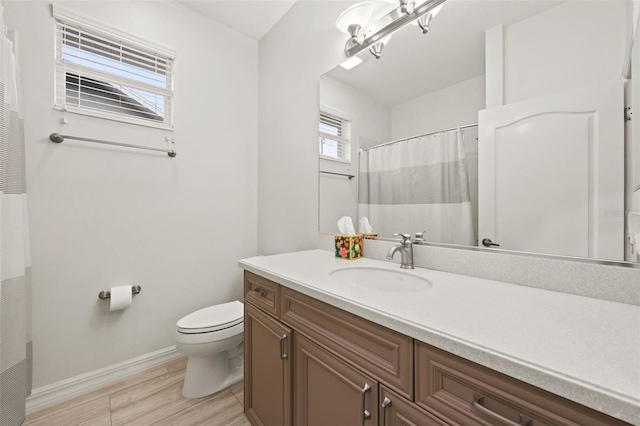 bathroom featuring vanity, hardwood / wood-style floors, and toilet