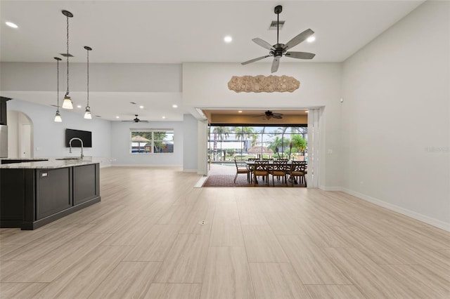 kitchen featuring ceiling fan, plenty of natural light, and hanging light fixtures