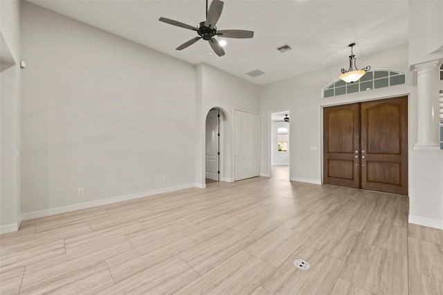 interior space featuring ornate columns and ceiling fan