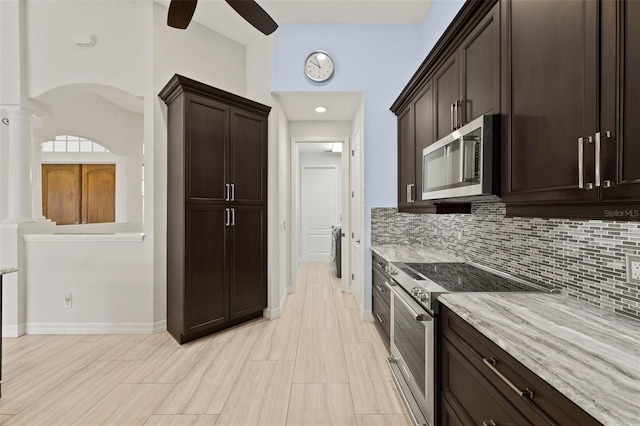 kitchen with backsplash, dark brown cabinets, stainless steel appliances, light stone counters, and ornate columns