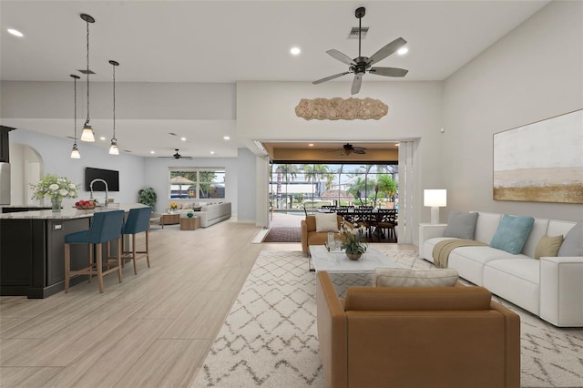 living room featuring ceiling fan and light hardwood / wood-style flooring