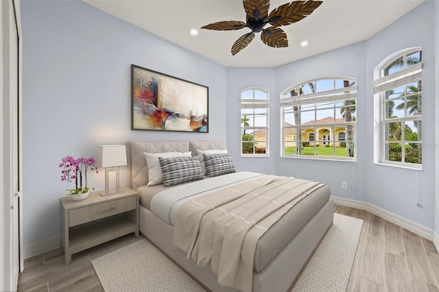 bedroom with ceiling fan and light wood-type flooring