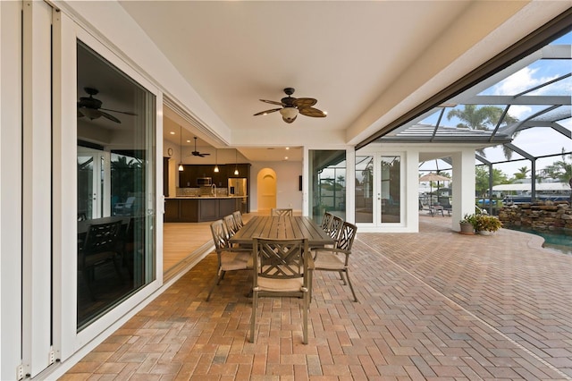 sunroom featuring ceiling fan