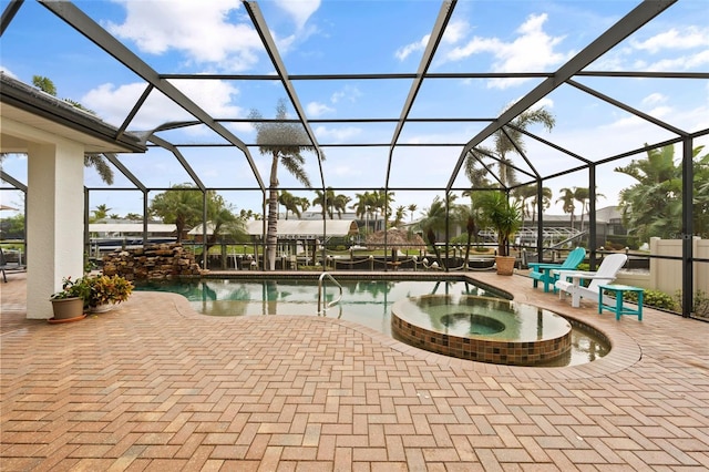 view of swimming pool with an in ground hot tub, a patio, and glass enclosure