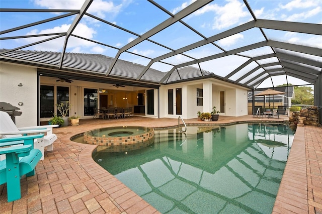 view of pool featuring an in ground hot tub, a lanai, and a patio