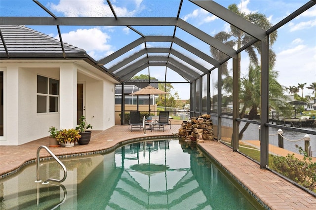 view of swimming pool featuring a lanai and a patio area