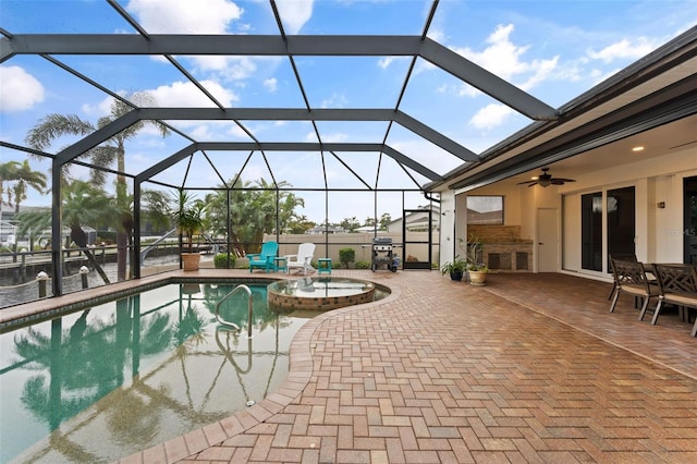 view of swimming pool featuring area for grilling, a patio, ceiling fan, and glass enclosure