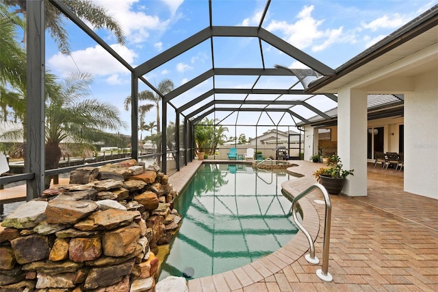 view of swimming pool with a patio and a lanai