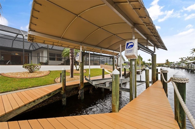 dock area with a lanai, a lawn, and a water view