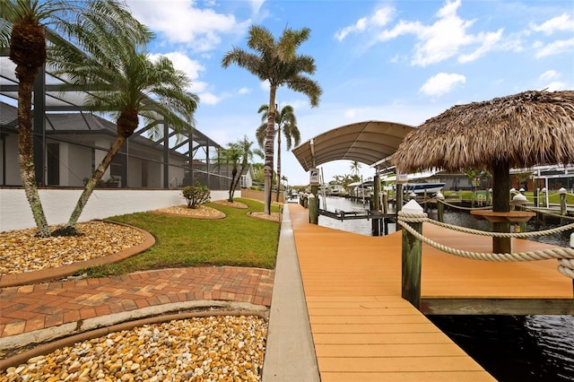 view of dock with a lanai and a water view