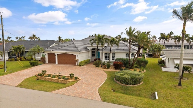 view of front of house featuring a garage and a front yard