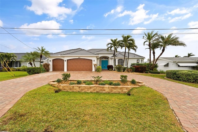 ranch-style home with a garage and a front lawn