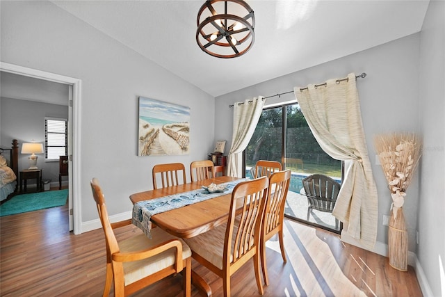 dining area featuring lofted ceiling and hardwood / wood-style flooring