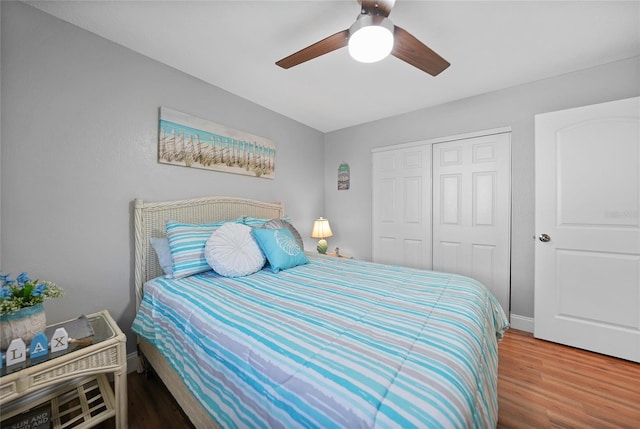 bedroom featuring hardwood / wood-style flooring, ceiling fan, and a closet