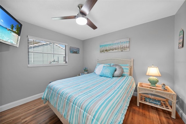 bedroom with ceiling fan and dark hardwood / wood-style floors